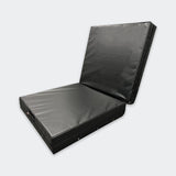Photo of Combat Corner's black Made in the USA Crash Pad, made for MMA, Wrestling, BJJ, Judo, Martial Arts, and more, folded at right angle to cover the gym floor and wall.