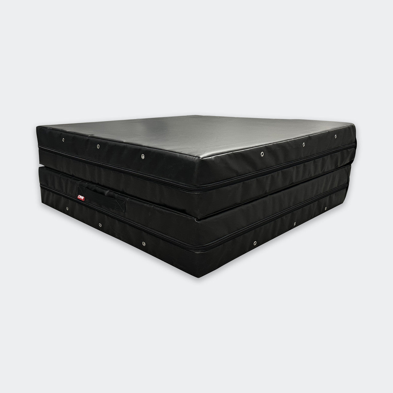 Photo of Combat Corner's black Made in the USA Crash Pad, made for MMA, Wrestling, BJJ, Judo, Martial Arts, and more, fully folded showing how easy it is to stack and store the crash pad.