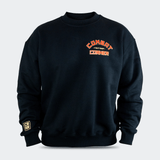 Front view of the Fire Fight Crew crewneck sweater by Combat Corner, featuring an arched orange and white graphic on the left chest that reads "Combat Fight Shop Corner" and a gold cuff tag.