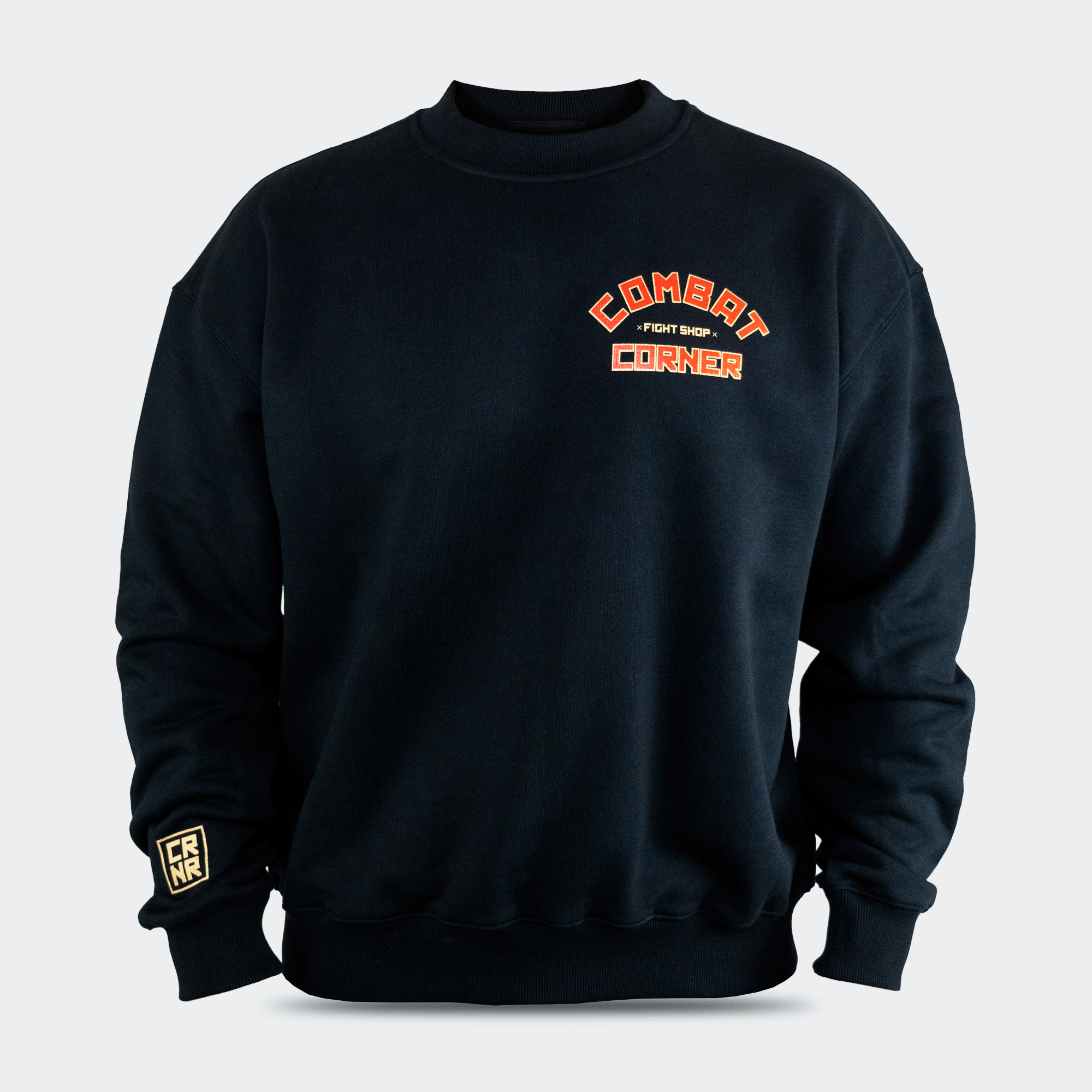 Front view of the Fire Fight Crew crewneck sweater by Combat Corner, featuring an arched orange and white graphic on the left chest that reads "Combat Fight Shop Corner" and a gold cuff tag.