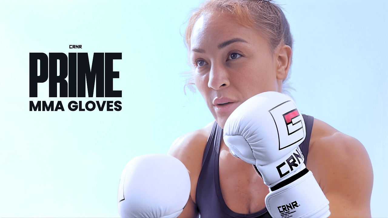 A YouTube thumbnail graphic featuring a close-up profile of a focused female fighter holding up white Combat Corner Prime MMA sparring gloves, with bold text reading "PRIME MMA GLOVES" on the left.