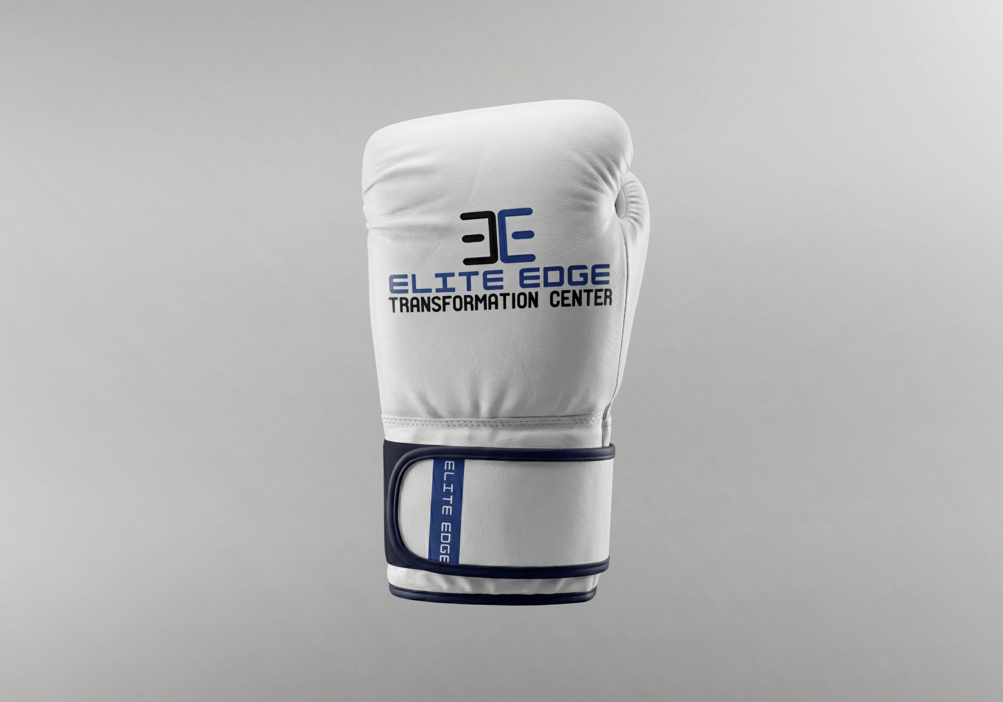 A custom white leather boxing glove by Combat Corner, featuring an "Elite Edge Transformation Center" logo on the main striking surface and matching blue trim on the wrist strap.