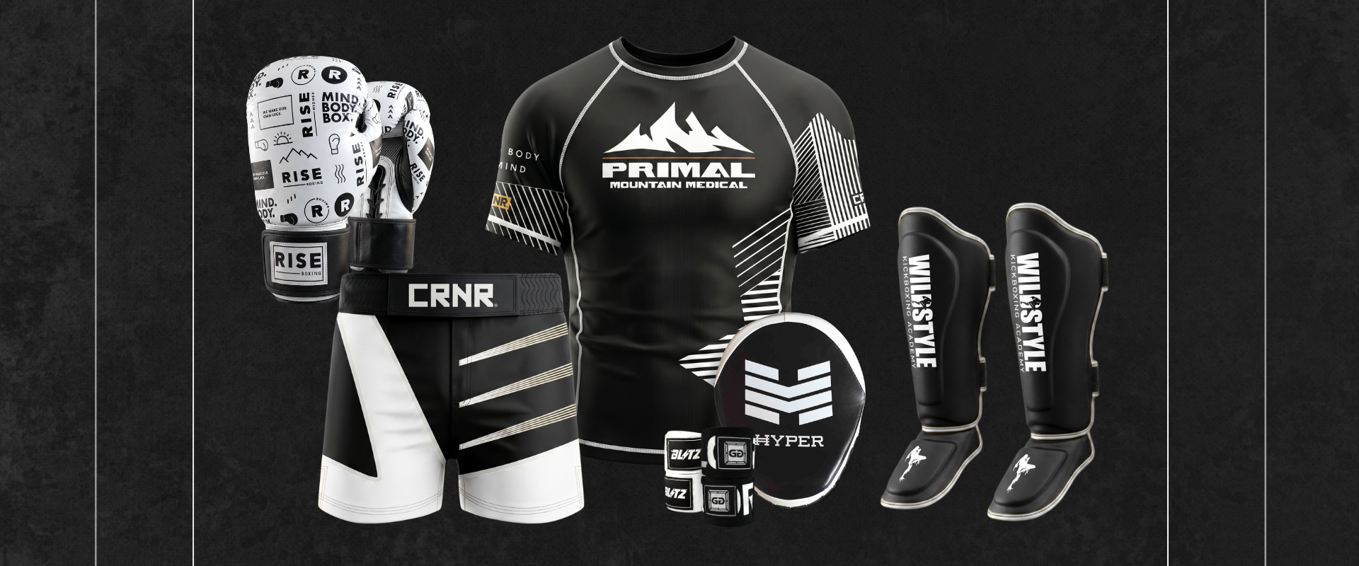 A product layout on a dark background showcasing custom-branded combat sports gear by Combat Corner, including doodle-patterned boxing gloves, a "Primal Mountain Medical" rash guard, black and white "CRNR" fight shorts, hand wraps, a focus mitt, and "Willstyle" shin guards.