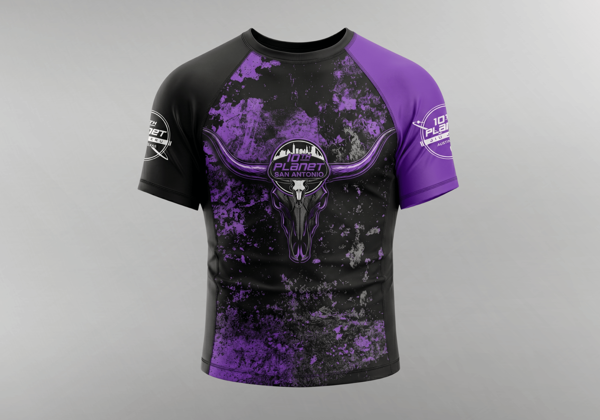 A custom short-sleeve rash guard by Combat Corner, featuring a black and purple distressed grunge pattern with a 10th Planet San Antonio longhorn graphic on the chest.
