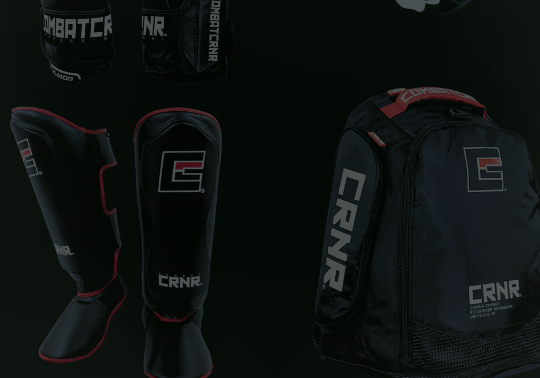 A product display of black combat sports gear from Combat Corner against a dark background, including boxing gloves, shin guards, and gym bags. 