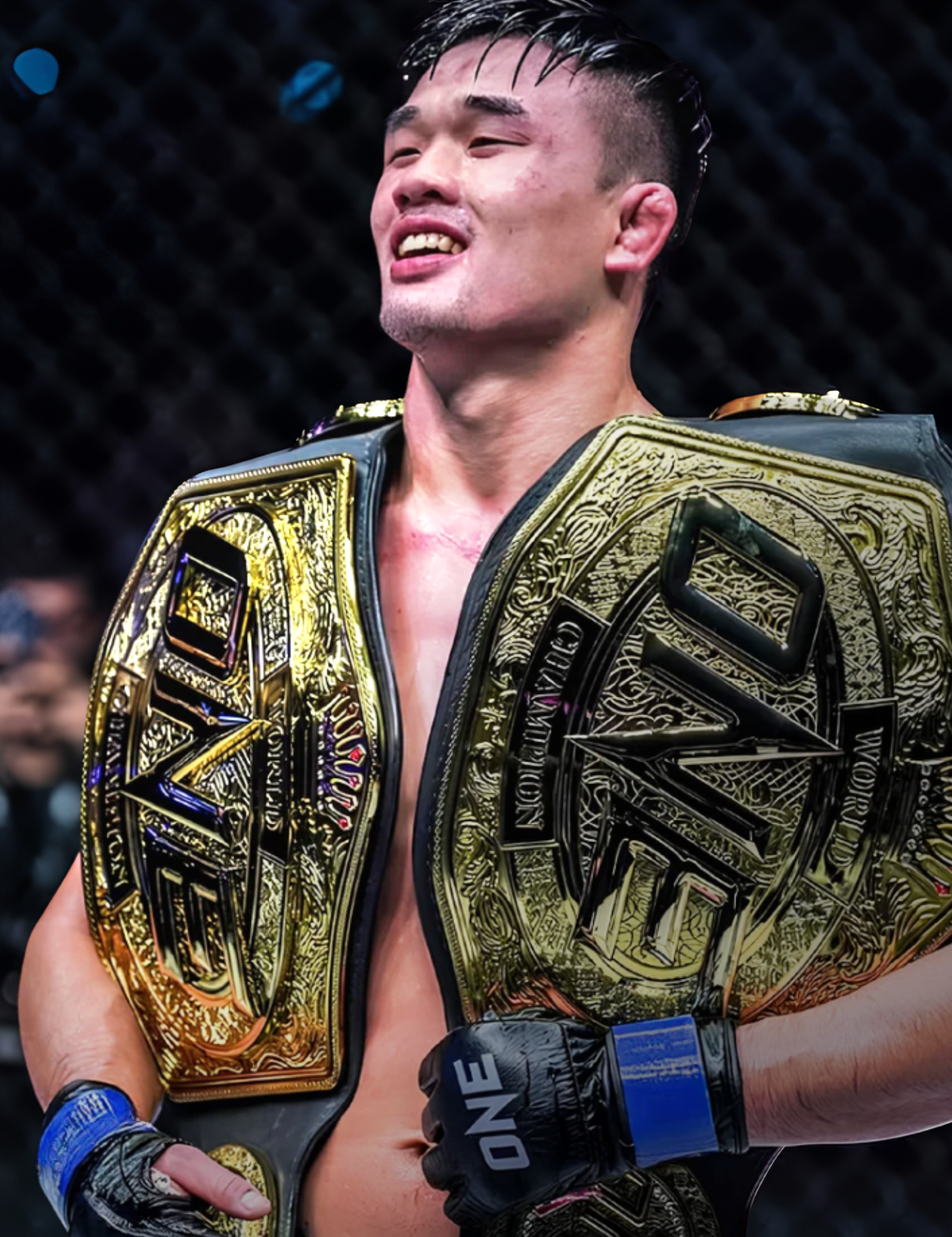Close-up of ONE World Champion and Combat Corner Pro Team Member Christian Lee celebrating a victory inside the cage, wearing blue-wrapped Combat Corner ONE Championship MMA gloves while draped in two large gold ONE world championship belts. 