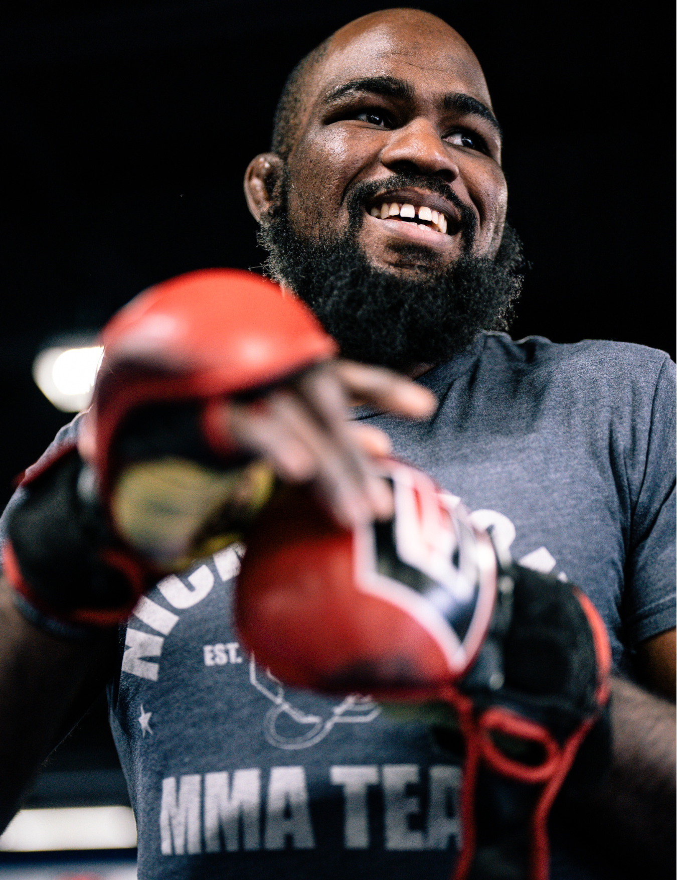 Low-angle close-up of a PFL Light Heavyweight World Champion and Bellator Light Heavyweight World Champion and Combat Corner Pro Team Member Corey Anderson training with Combat Corner’s Elite MMA Training Gloves. 