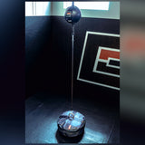 An in use example photo of the black CRNR Punching Bag Anchor with a top metal ring attached to a double end punching bag. 