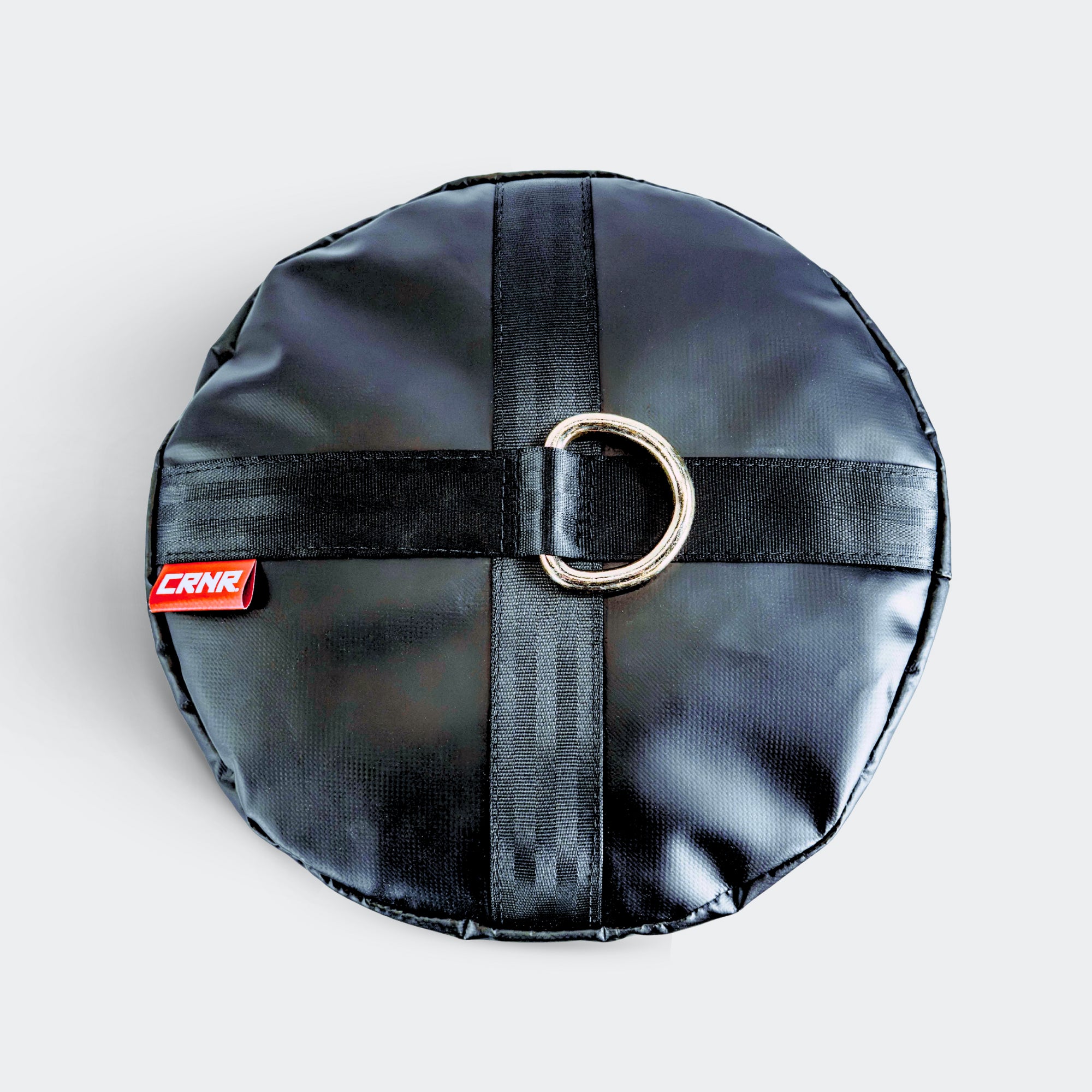 Top down view of the black CRNR Punching Bag Anchor with a top metal ring.