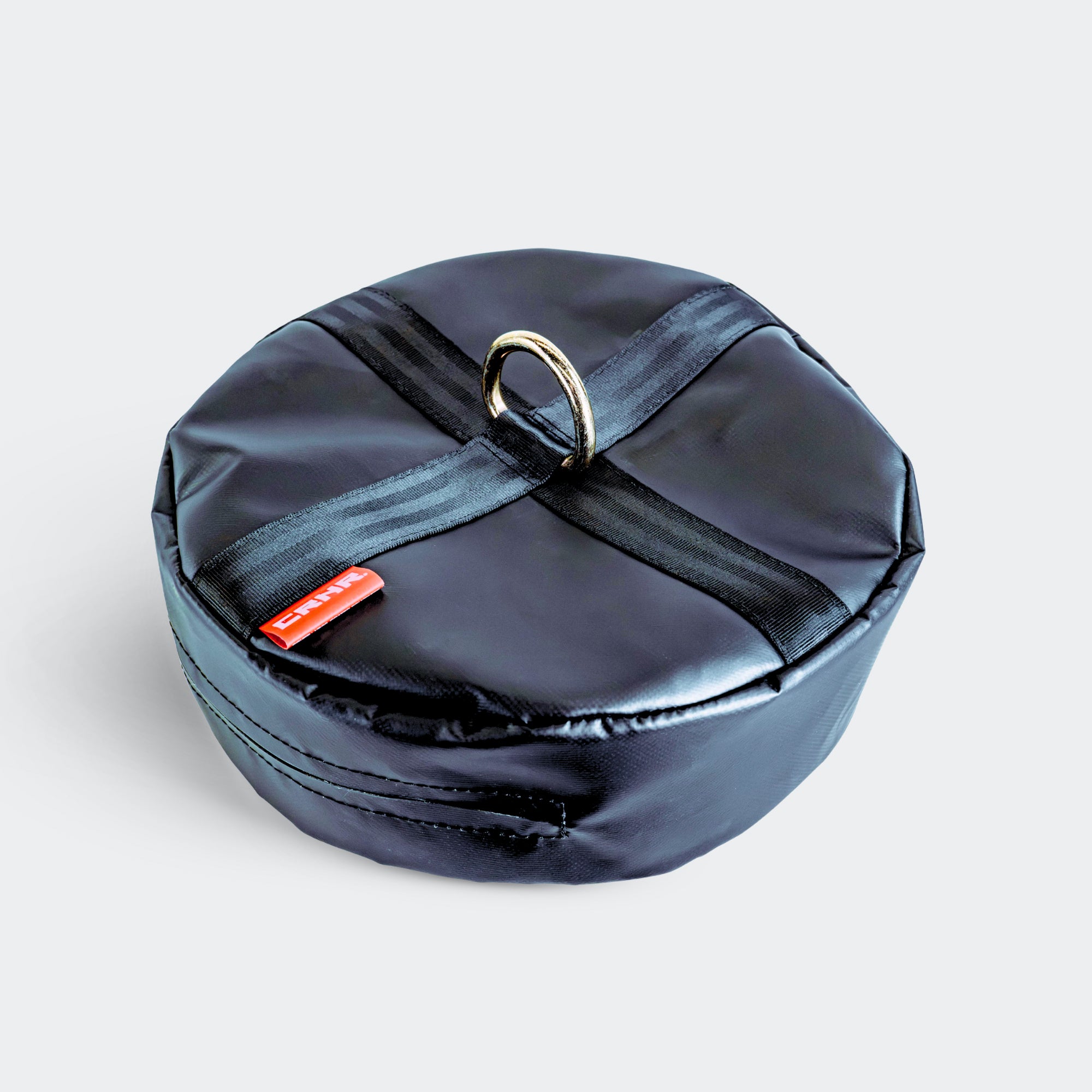 Top-left front angle view of the black CRNR Punching Bag Anchor with a top metal ring.