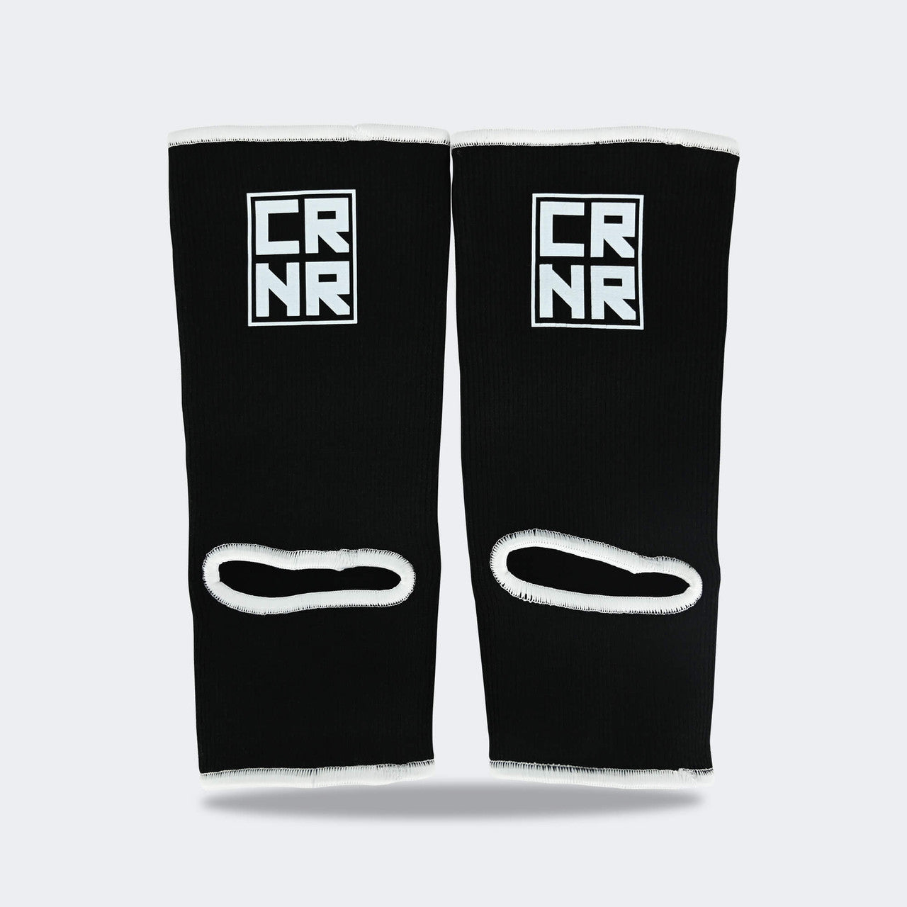Product photo of Combat Corner’s exclusive Black HMIT Ankle Supports. This photo shows the back of Combat Corner’s Black HMIT Ankle Supports. These Black HMIT Ankle Supports are part of the full HMIT (Hand Made in Thailand) product line such as HMIT Lace Up Sparring Gloves, HMIT Full Face Headgear, and HMIT Tear Drop Heavy Bags.