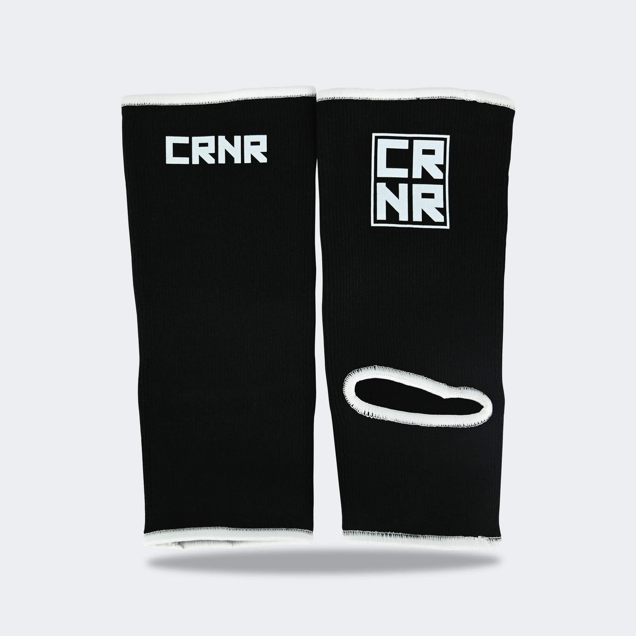 Product photo of Combat Corner’s exclusive Black HMIT Ankle Supports. This photo shows the back of Combat Corner’s Black HMIT Ankle Supports. These Black HMIT Ankle Supports are part of the full HMIT (Hand Made in Thailand) product line such as HMIT Lace Up Sparring Gloves, HMIT Full Face Headgear, and HMIT Tear Drop Heavy Bags.