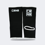 Product photo of Combat Corner’s exclusive Black HMIT Ankle Supports. This photo shows the back of Combat Corner’s Black HMIT Ankle Supports. These Black HMIT Ankle Supports are part of the full HMIT (Hand Made in Thailand) product line such as HMIT Lace Up Sparring Gloves, HMIT Full Face Headgear, and HMIT Tear Drop Heavy Bags.