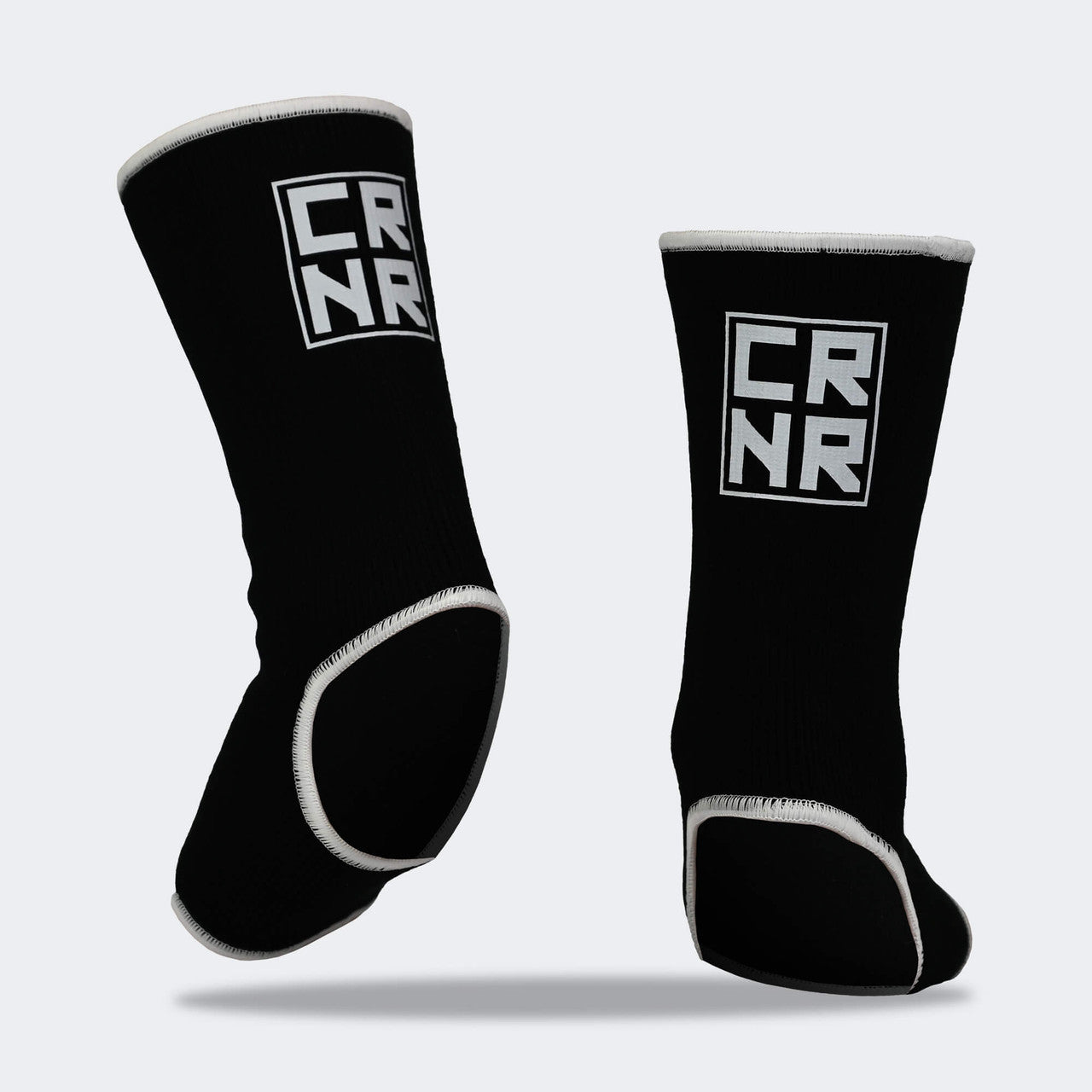 Product photo of Combat Corner’s exclusive Black HMIT Ankle Supports. This photo shows the back on foot of Combat Corner’s Black HMIT Ankle Supports. These Black HMIT Ankle Supports are part of the full HMIT (Hand Made in Thailand) product line such as HMIT Lace Up Sparring Gloves, HMIT Full Face Headgear, and HMIT Tear Drop Heavy Bags.