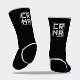 Product photo of Combat Corner’s exclusive Black HMIT Ankle Supports. This photo shows the back on foot of Combat Corner’s Black HMIT Ankle Supports. These Black HMIT Ankle Supports are part of the full HMIT (Hand Made in Thailand) product line such as HMIT Lace Up Sparring Gloves, HMIT Full Face Headgear, and HMIT Tear Drop Heavy Bags.