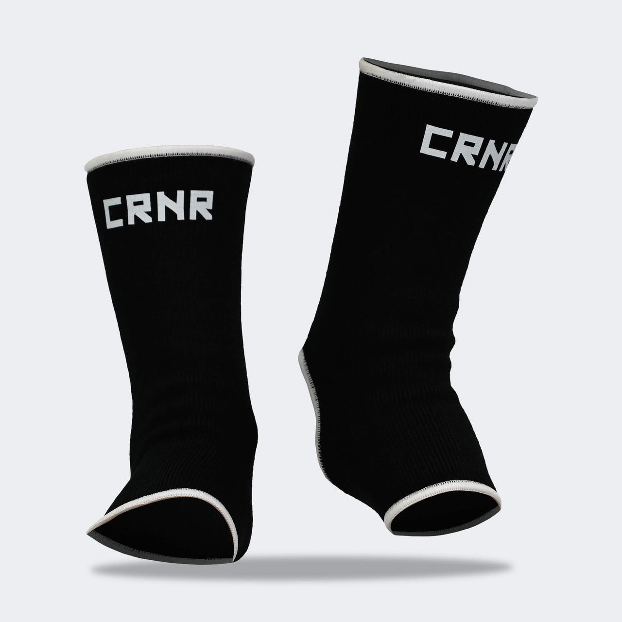 Product photo of Combat Corner’s exclusive Black HMIT Ankle Supports. This photo shows the front on foot of Combat Corner’s Black HMIT Ankle Supports. These Black HMIT Ankle Supports are part of the full HMIT (Hand Made in Thailand) product line such as HMIT Lace Up Sparring Gloves, HMIT Full Face Headgear, and HMIT Tear Drop Heavy Bags.
