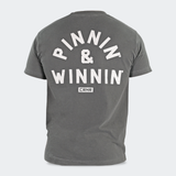 Product photo of Combat Corner’s exclusive Pinnin’ & Winnin’ Relaxed Tee. This photo shows the back of Combat Corner’s Pinnin’ & Winnin’ Faded Navy Relaxed Tee. This CRNR tee offers the same softness and comfort as your favorite, well-loved vintage tee.