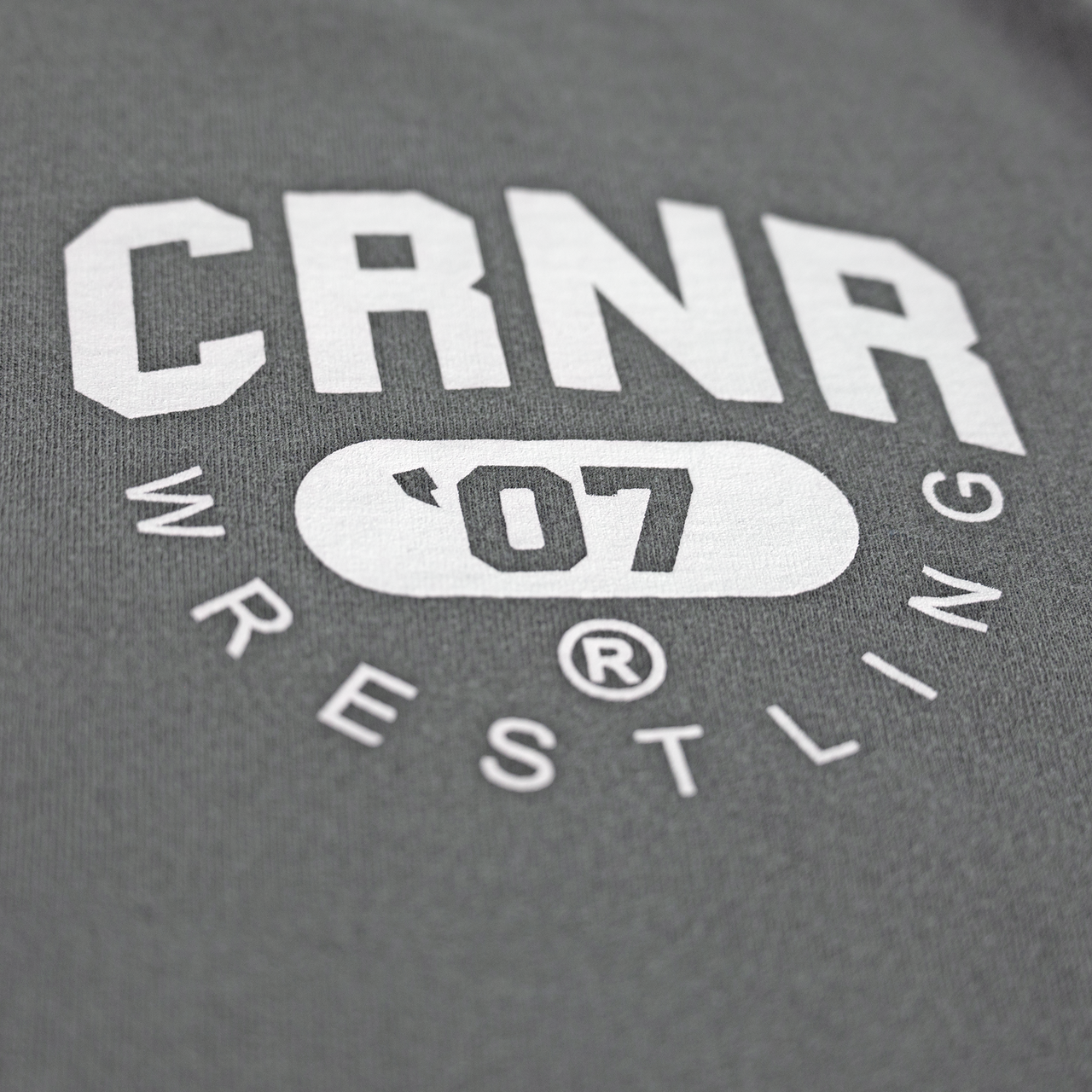 Product photo of Combat Corner’s exclusive Pinnin’ & Winnin’ Relaxed Tee. This photo shows a detail, close up on the delux screenprinted graphics on the front of Combat Corner’s Pinnin’ & Winnin’ Faded Navy Relaxed Tee. This CRNR tee offers the same softness and comfort as your favorite, well-loved vintage tee.