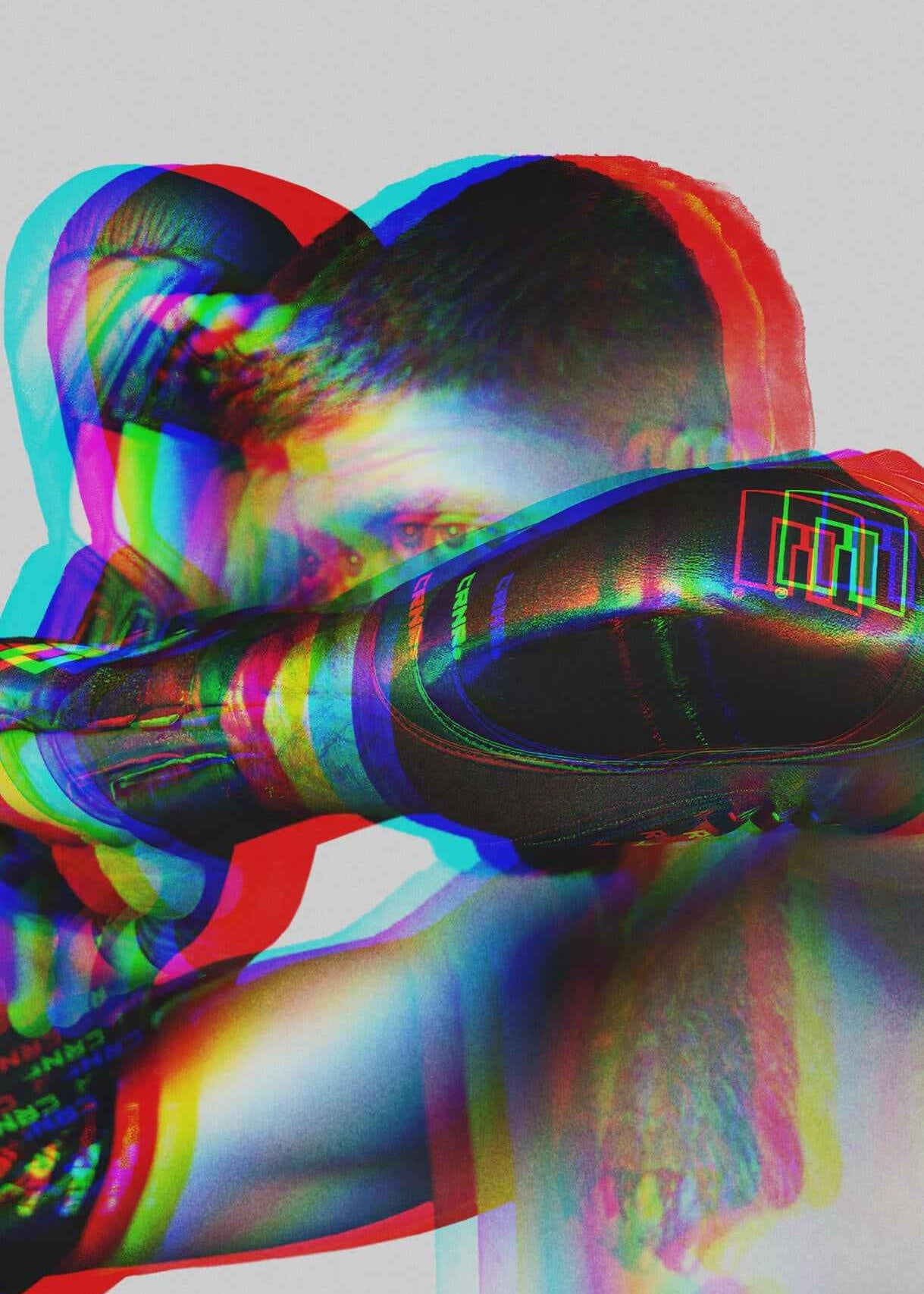 A stylized action photograph of a fighter shielding with their forearm while wearing a black Combat Corner Premium Elbow Pad, treated with a vibrant multi-colored 3D glitch effect overlay.