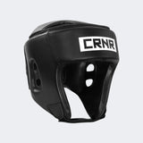 A product photo of the Combat Corner's black Competition Headgear. The photo shows the front left angle of Combat Corner's Competition Headgear. This competition headgear works for Muay Thai Headgear, USMF Headgear, IFMA Headgear, USA Muay Thai Headgear, Boxing Headgear, and Kickboxing headgear.