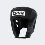 A product photo of the Combat Corner's black Competition Headgear. The photo shows the front right angle of Combat Corner's Competition Headgear. This competition headgear works for Muay Thai Headgear, USMF Headgear, IFMA Headgear, USA Muay Thai Headgear, Boxing Headgear, and Kickboxing headgear.