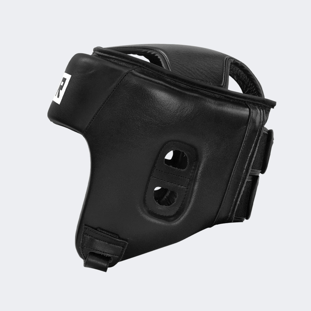 A product photo of the Combat Corner's black Competition Headgear. The photo shows the back left angle of Combat Corner's Competition Headgear. This competition headgear works for Muay Thai Headgear, USMF Headgear, IFMA Headgear, USA Muay Thai Headgear, Boxing Headgear, and Kickboxing headgear.