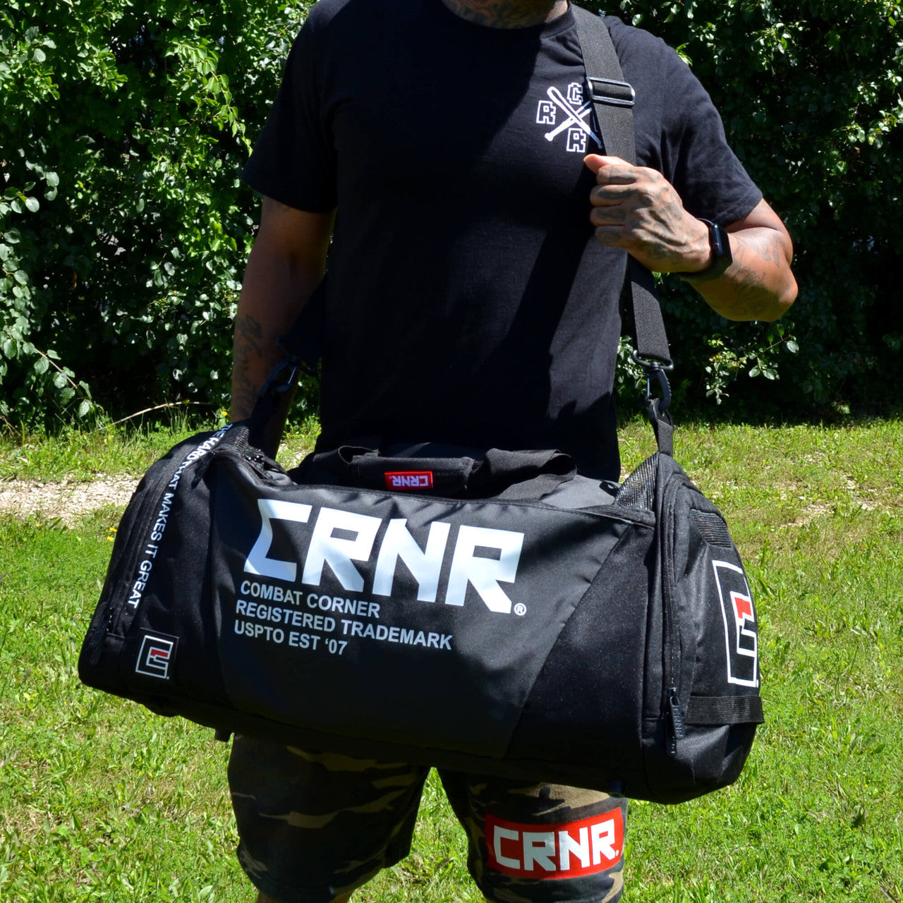 Photo of a man wearing the Combat Corner Essential Gear Bag as he's hiking and traveling
