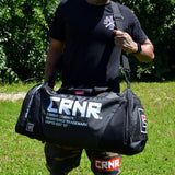 Photo of a man wearing the Combat Corner Essential Gear Bag as he's hiking and traveling