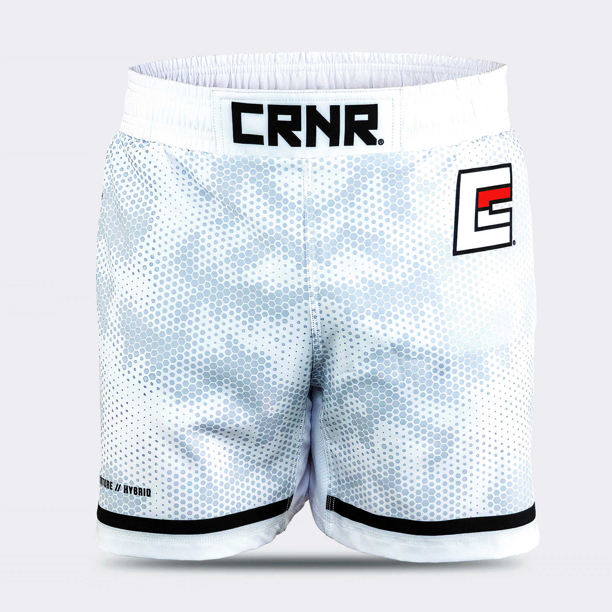 White Combat Corner hybrid fight shorts shown from the front against a light grey background. The shorts feature a white and grey hexagonal digital camouflage pattern, a wide white elastic waistband with a black "CRNR" logo patch centered, a black and red stylized "E" logo on the left thigh, and black trim along the bottom hems.