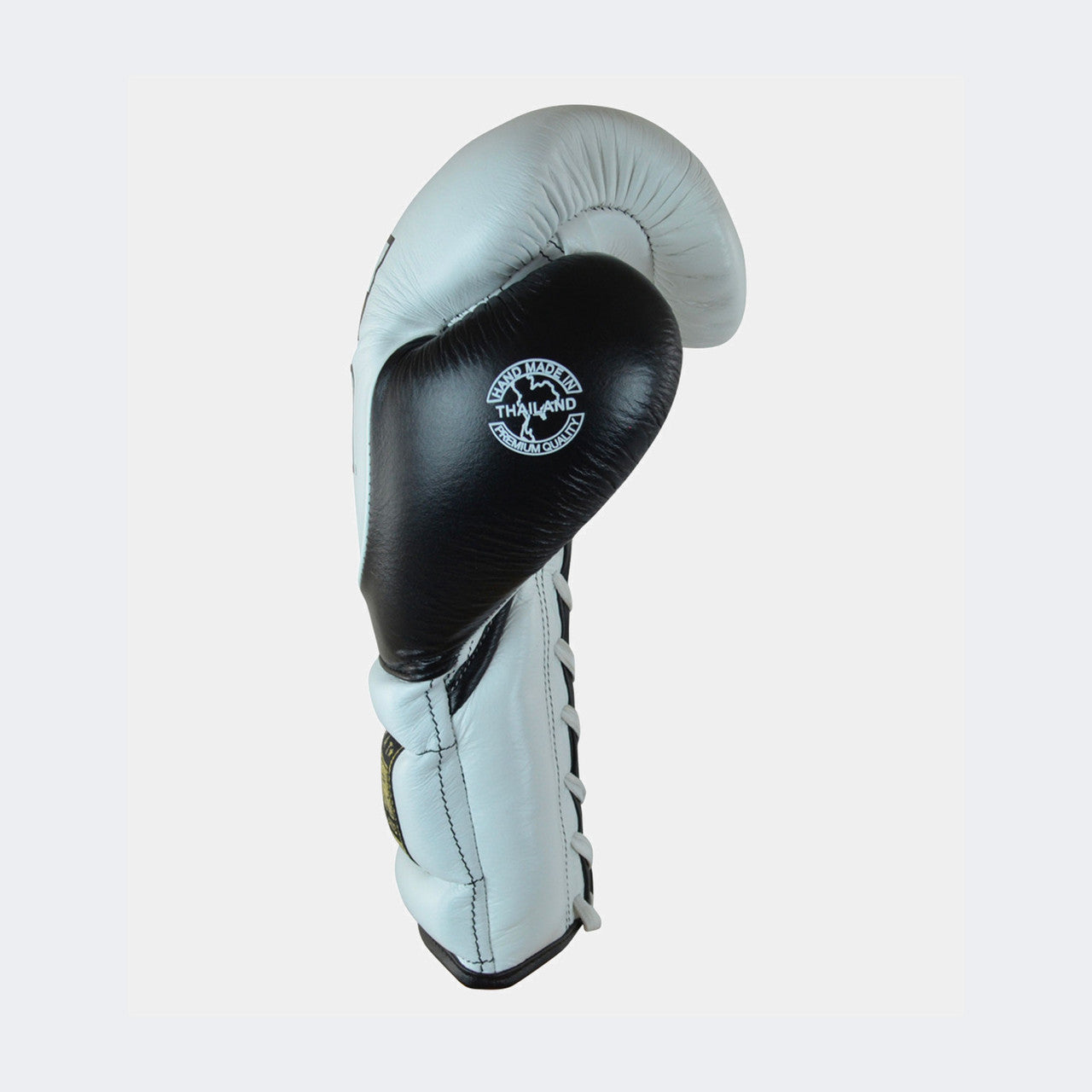 Photo of the left side of Combat Corner's white and black HMIT Lace Up Sparring Gloves, which are Mexican Boxing Gloves that are hand made in Thailand.