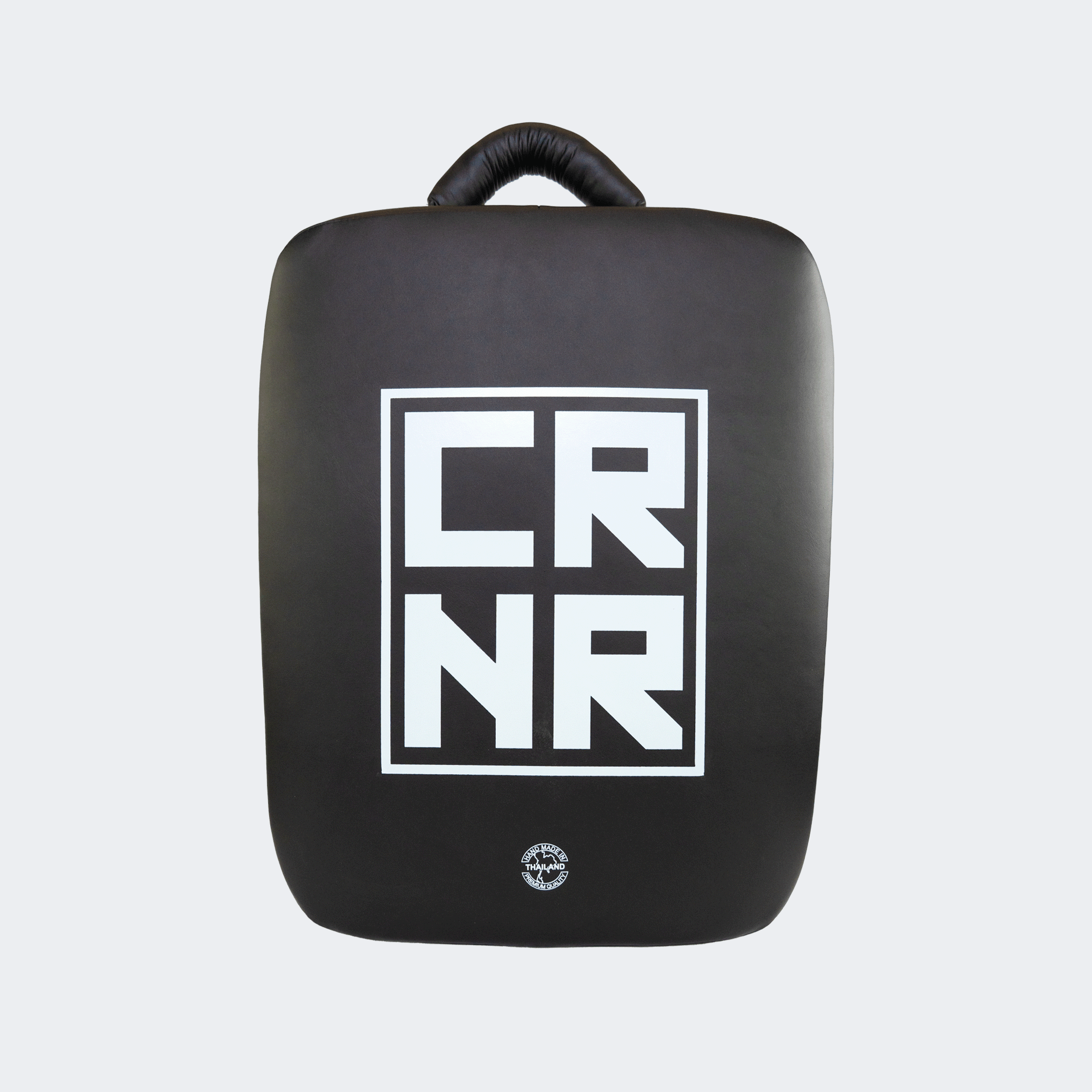 Front view of the HMITV Low Kick Pad Lite, a large, black leather martial arts low kick shield pad by Combat Corner against a light grey background, featuring a white block "CRNR" logo on the striking surface.