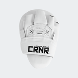 The back of the white HMITV Curved Punch Mitts by Combat Corner against a solid light grey background, showcasing the curved hand compartment and front striking surface.
