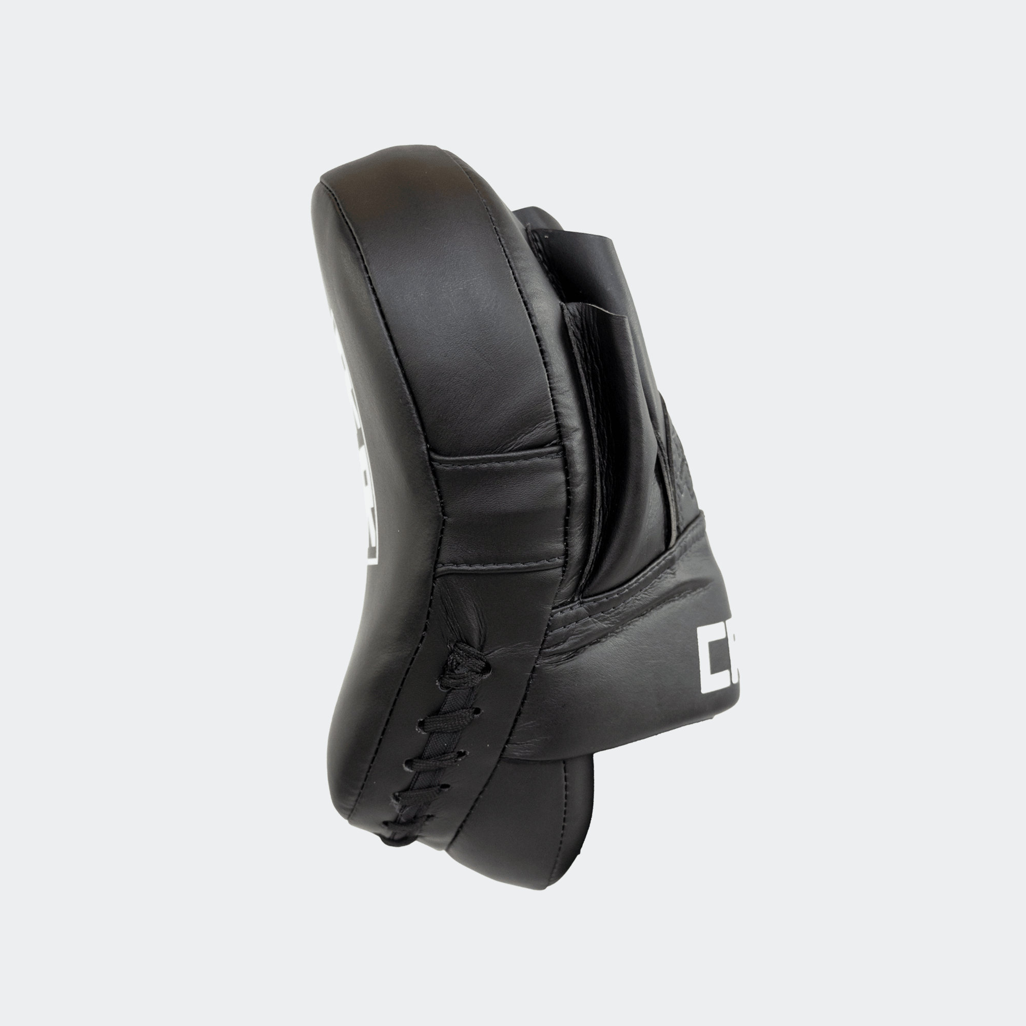 The right side view of the black HMITV Curved Punch Mitts by Combat Corner against a solid light grey background, showcasing the curved hand compartment and front striking surface.