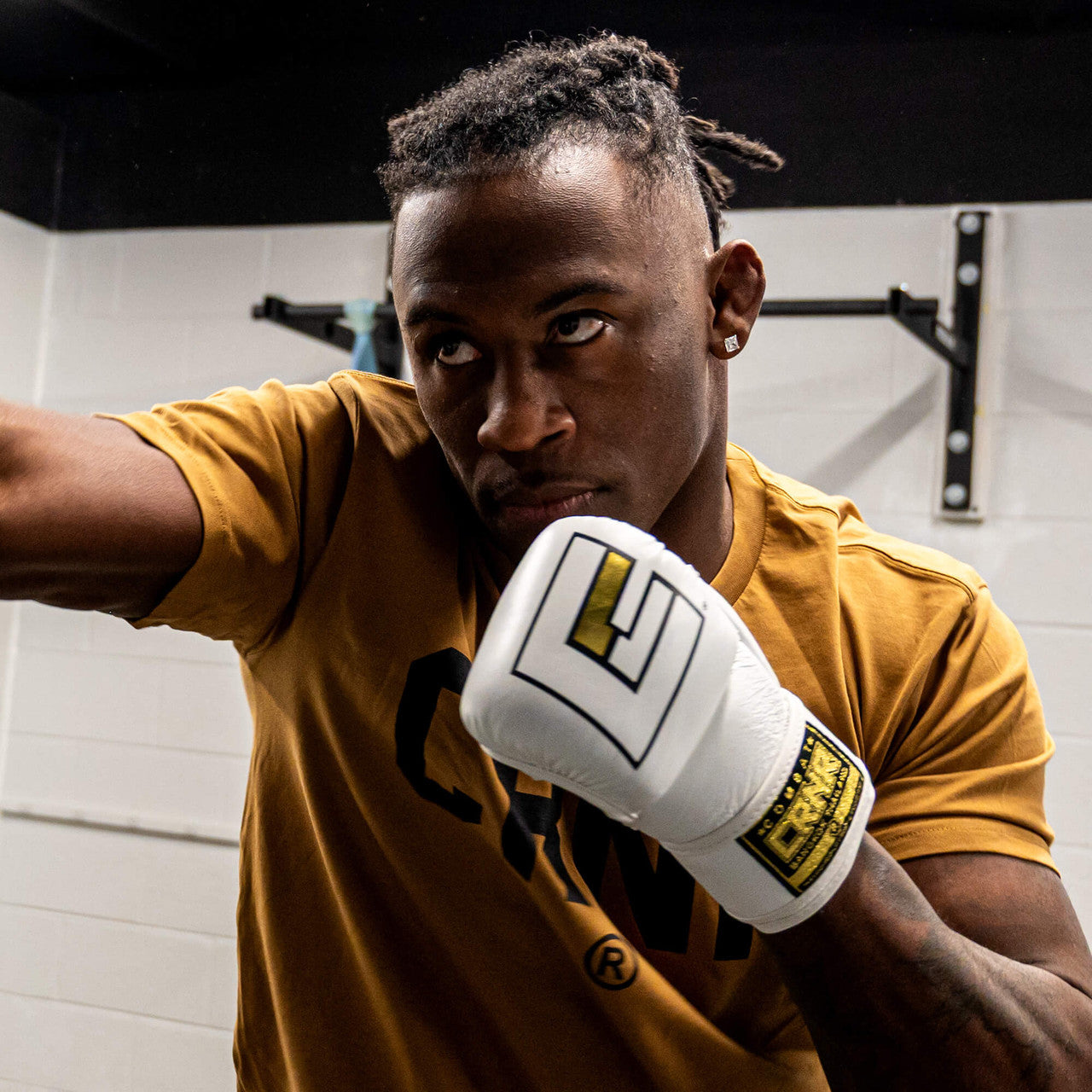 Photo of an athlete training with the white Combat Corner HMIT MMA Training Glove