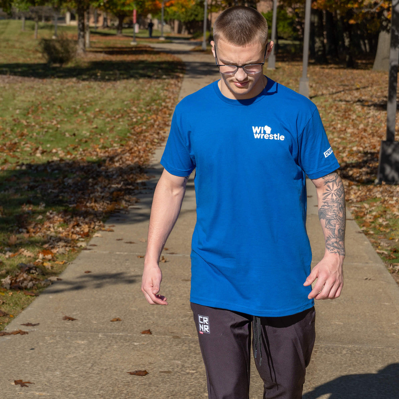 Product photo of Combat Corner’s exclusive WI Wrestle Blue Classic Tee. This photo shows the front of Combat Corner’s WI Wrestle Blue Classic Tee. This collab Classic Tee is part of Combat Corner’s sponsorship of WI Wrestle, the number one news source and fan center for Wisconsin wrestling.
