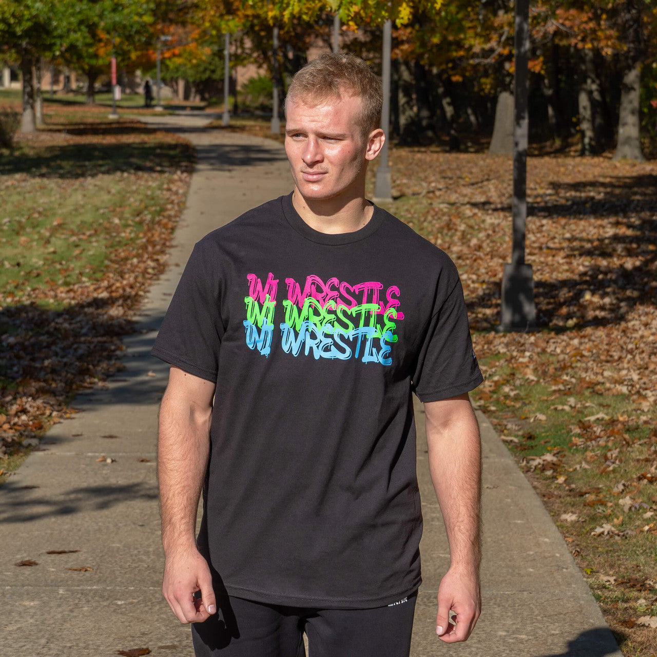 Product photo of Combat Corner’s exclusive WI Wrestle Neon Tee. This photo shows the front of Combat Corner’s WI Wrestle Neon Tee. This collab Neon Tee is part of Combat Corner’s sponsorship of WI Wrestle, the number one news source and fan center for Wisconsin wrestling.