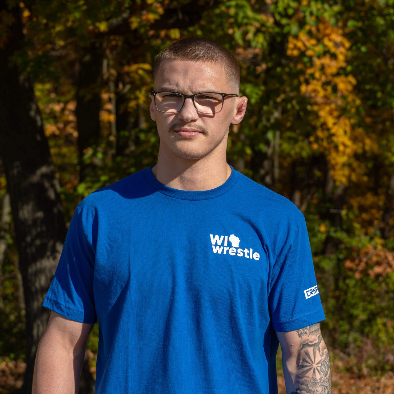 Product photo of Combat Corner’s exclusive WI Wrestle Blue Classic Tee. This photo shows the front of Combat Corner’s WI Wrestle Blue Classic Tee. This collab Classic Tee is part of Combat Corner’s sponsorship of WI Wrestle, the number one news source and fan center for Wisconsin wrestling.