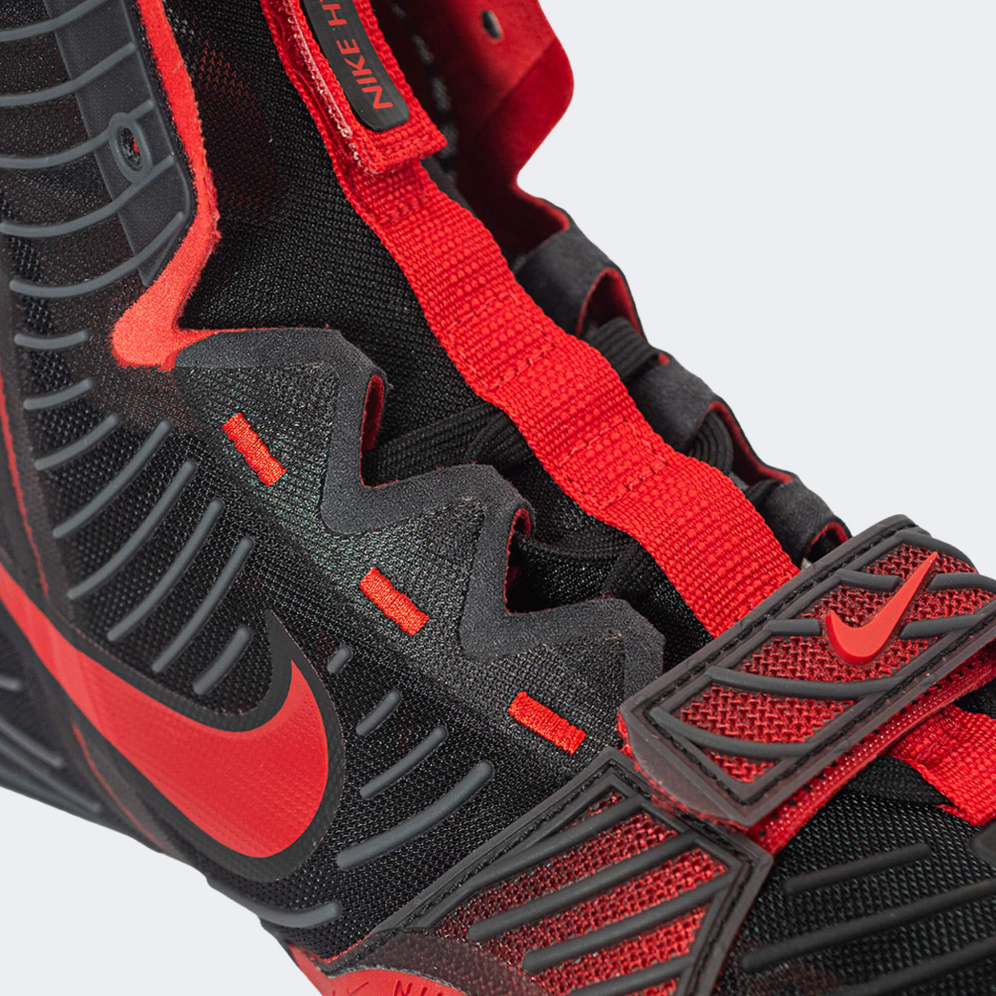 Close-up detailed view of the strap and lacing system on the Nike HyperKO 3 in university black and red boxing shoe, available at Combat Corner.