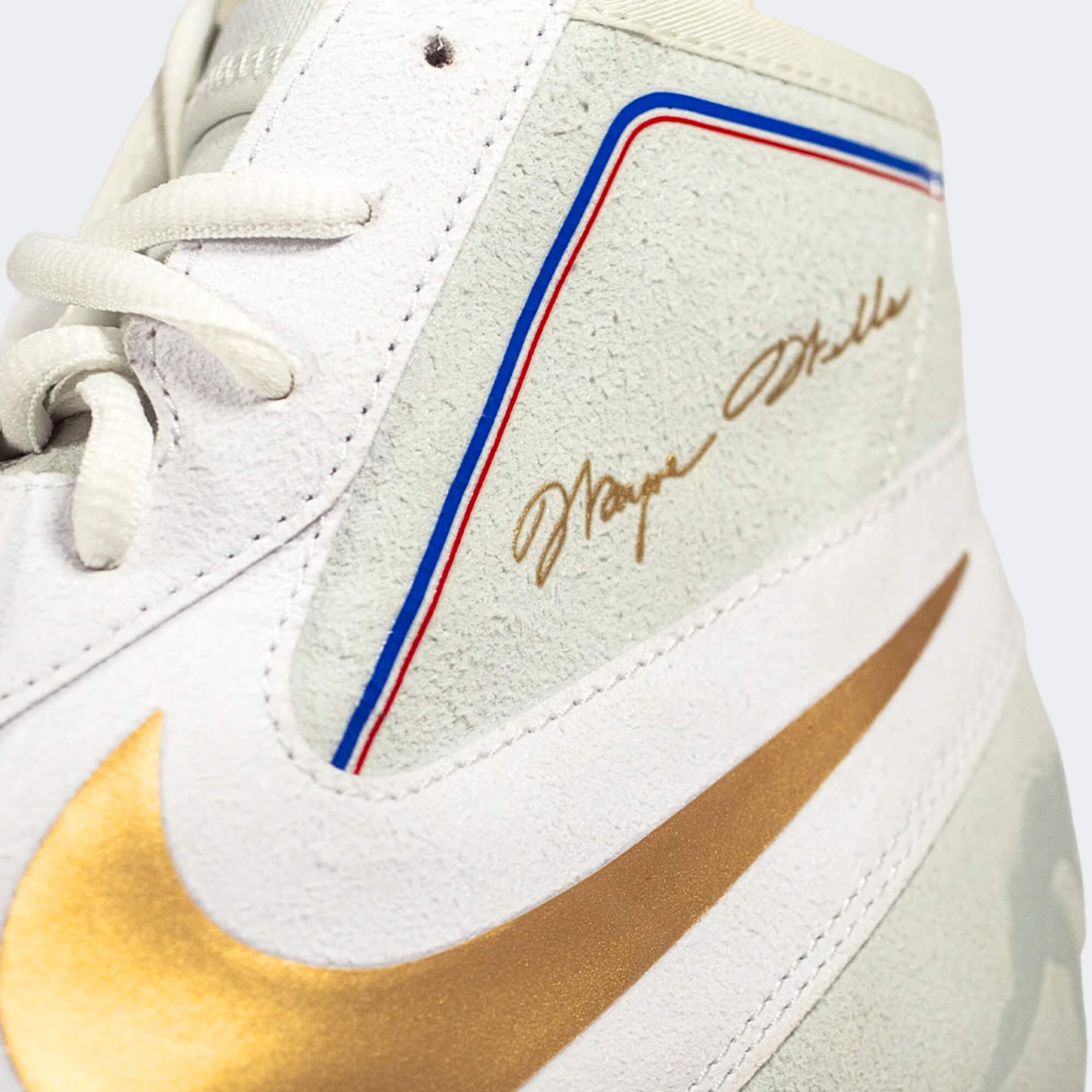 Close up detail photo of the Wayne Wells signature on the inner outsole of the Nike Footsweep 2 wrestling shoe in SE Photon, available from Combat Corner.