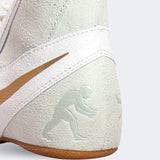 Close up detail photo of the wrestler icon on the back heel of the Nike Footsweep 2 wrestling shoe in SE Photon, available from Combat Corner.
