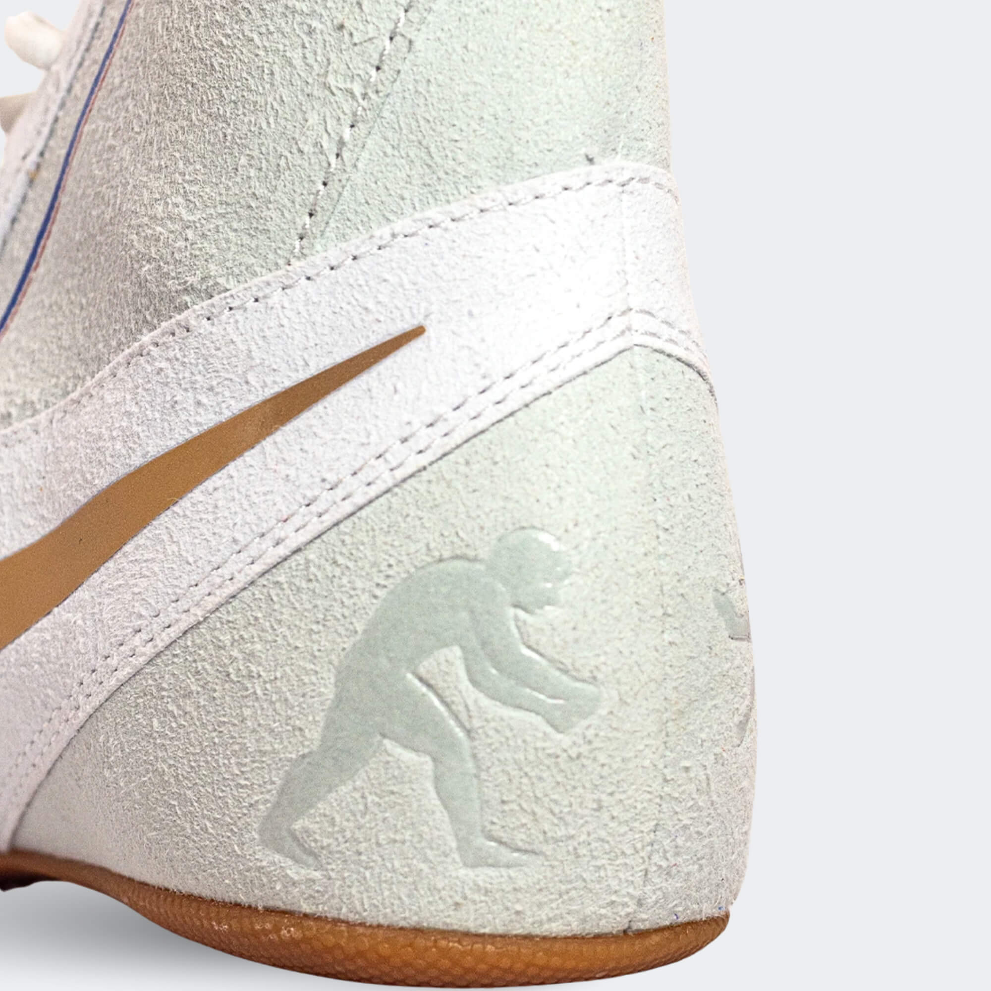 Close up detail photo of the wrestler icon on the back heel of the Nike Footsweep 2 wrestling shoe in SE Photon, available from Combat Corner.