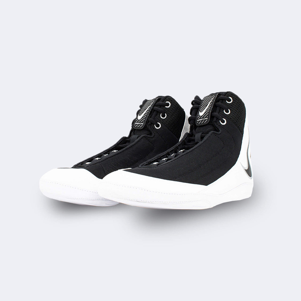 A pair of the Nike Inflict 4 wrestling shoes in black from the front left angle, available from Combat Corner.
