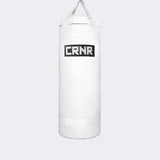 Photo of the front of Combat Corner's white with black label 150 lbs. Made in the USA Punching Bag.