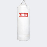 Photo of the front of Combat Corner's white with red label 150 lbs. Made in the USA Punching Bag.