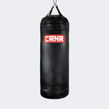 Photo of the front of Combat Corner's black with red label 150 lbs. Made in the USA Punching Bag.
