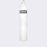 Photo of the front of Combat Corner's white with black label 6 ft., 150 lbs. Made in the USA Punching Bag.
