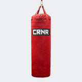 Photo of the front of Combat Corner's red with black label 100 lbs. Made in the USA Punching Bag.