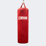 Photo of the front of Combat Corner's red with red label 100 lbs. Made in the USA Punching Bag.
