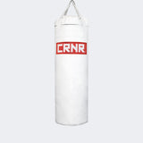 Photo of the front of Combat Corner's white with red label 80 lbs. Made in the USA Punching Bag.