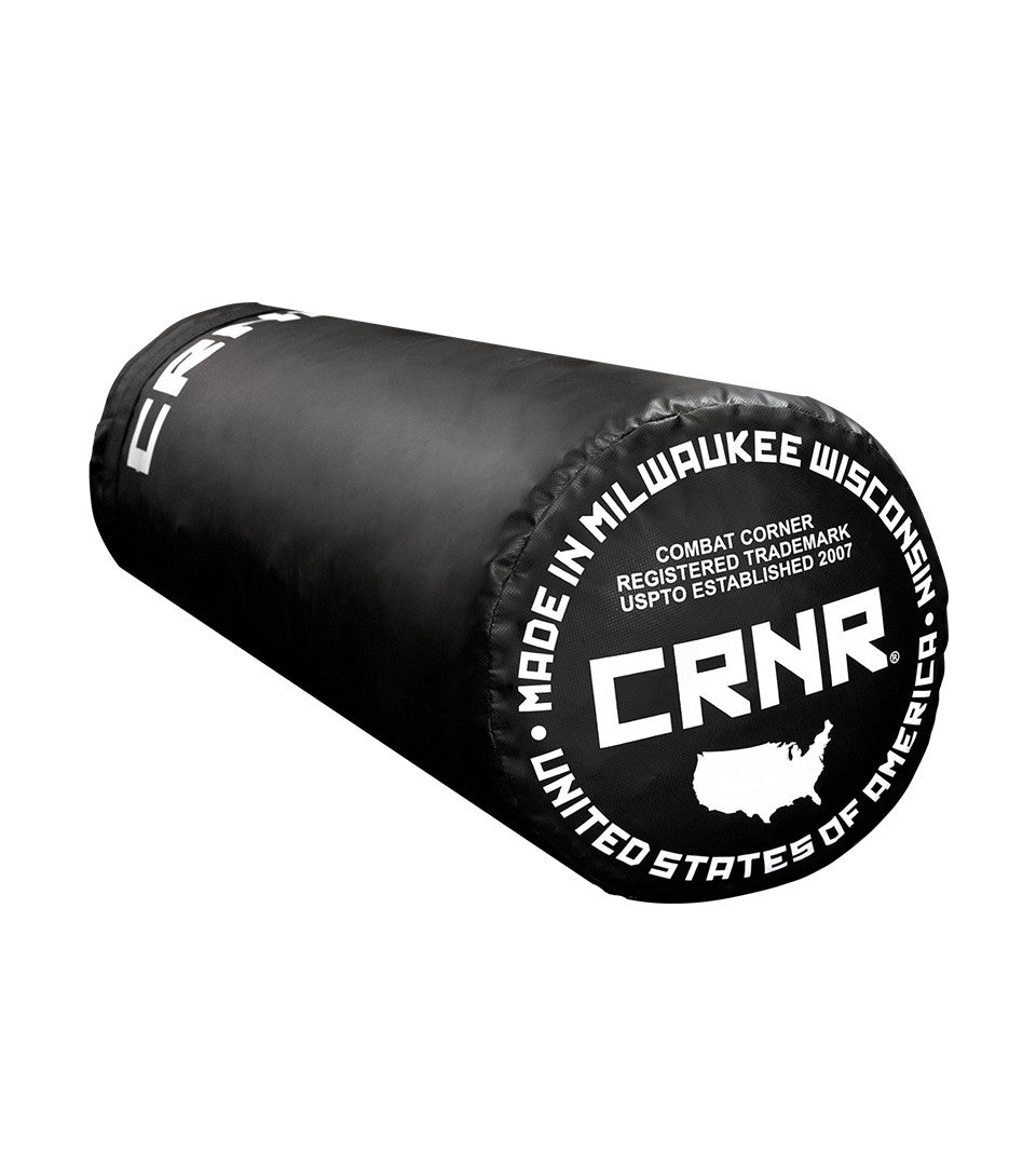 Photo of the bottom of Combat Corner's black with black label 100 lbs. Made in the USA Punching Bag, which shows the under bag specialty Made in Milwaukee CRNR Label.